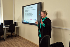 Na zdjęciu dr A. Migała-Warchoł podczas prowadzenia zajęć dla studentów. Ujęcie pod kątem, na pierwszym planie dr A. Migała-Warchoł,  